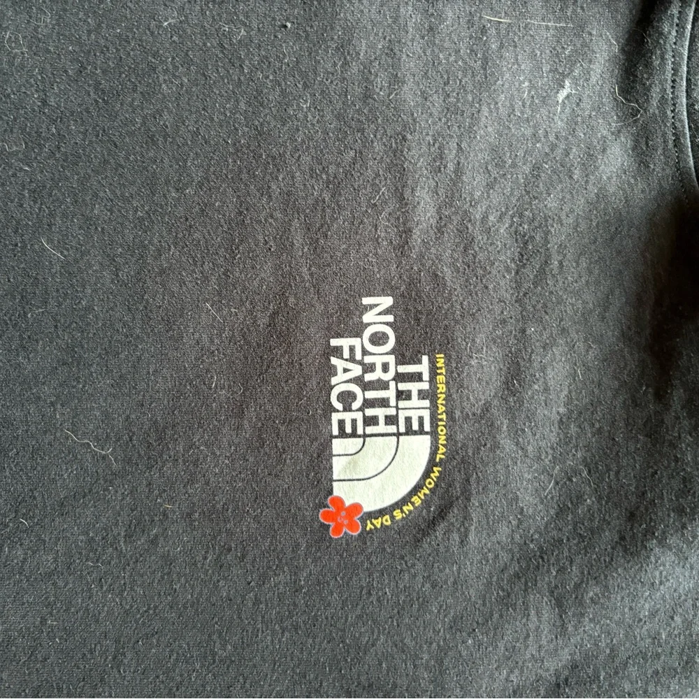 The North Face Black Tee with Yellow-Green Gradient Logo and Red Floral Accent - Picture 1 of 3